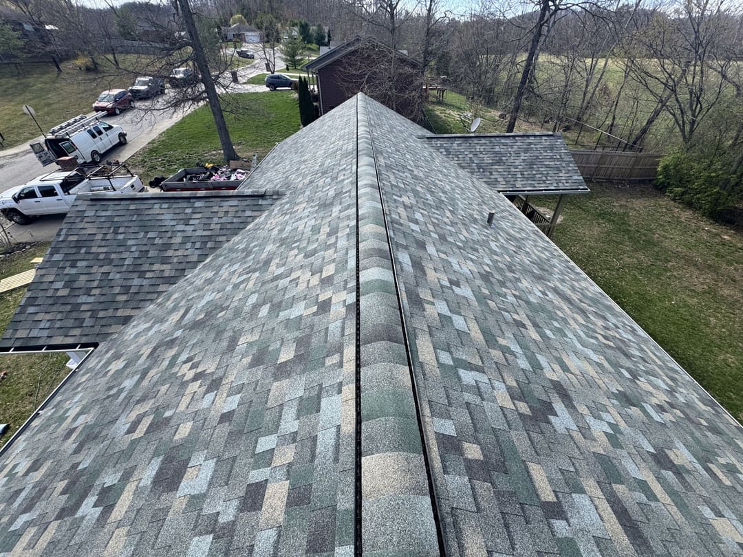 Ridge line of a new architectural shingle roof looking out over the street