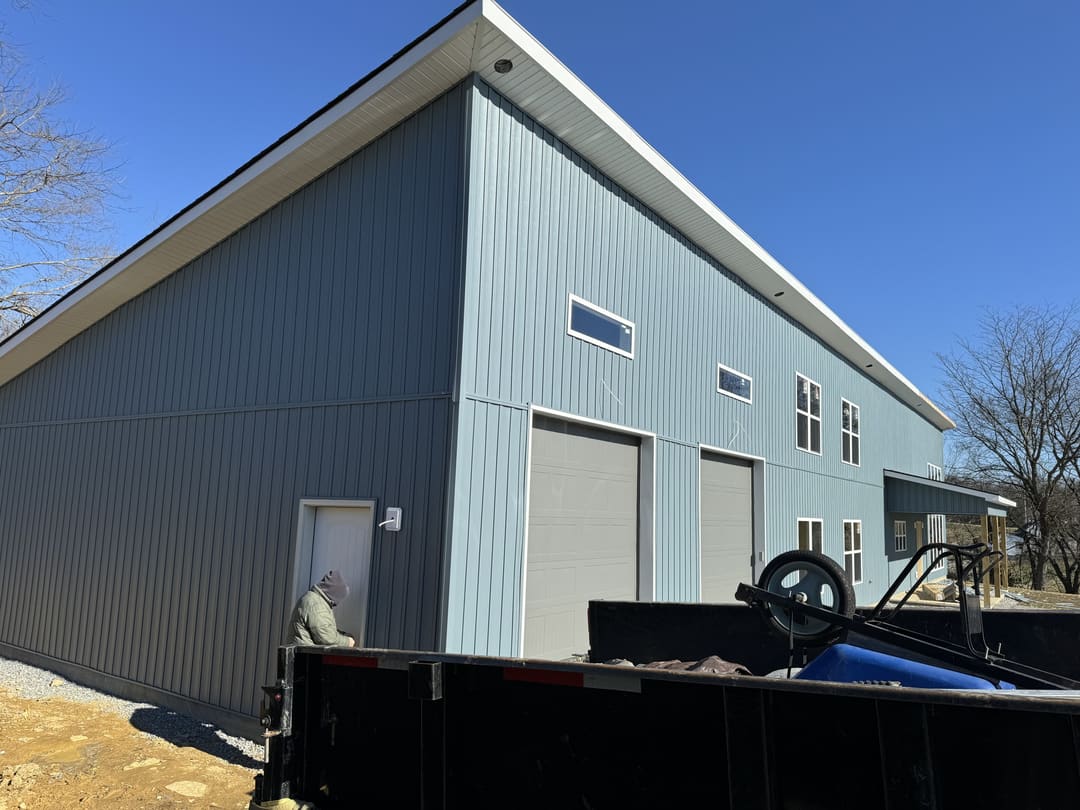 Shop bays and blue gray metal siding on a new commercial building