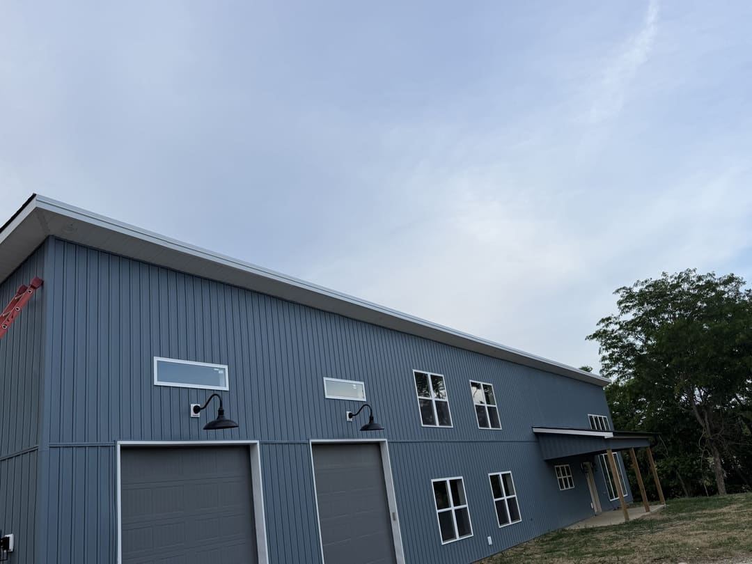 Blue gray metal siding on a large two bay shop building