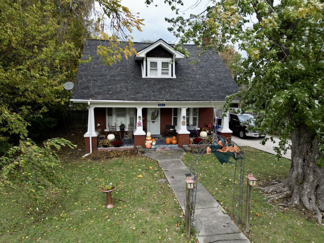 Gray shingle roof on a craftsman bungalow with a front porch and dormer