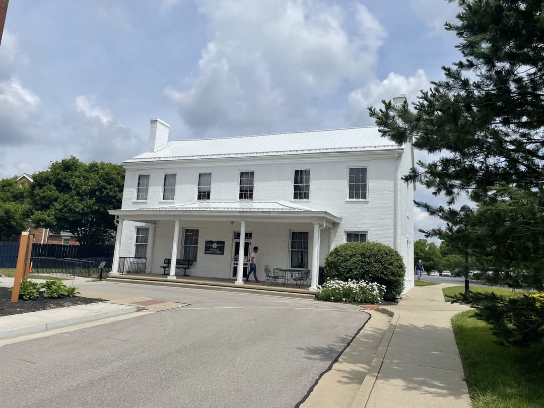 Front porch and standing seam roof of a historic white building
