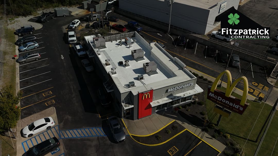 Harrodsburg McDonald's from the air at an angle, its white membrane roof and rooftop units above the McDonald's storefront