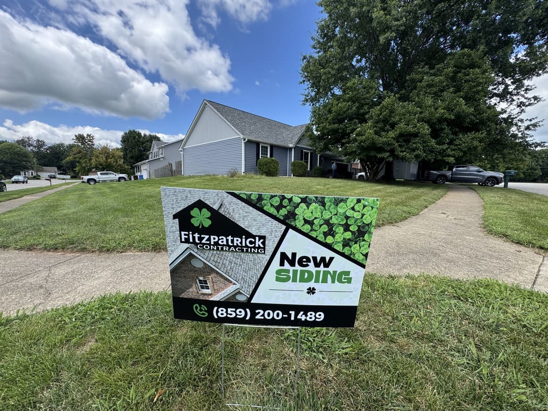 Fitzpatrick Contracting New Siding sign in the yard of a finished job