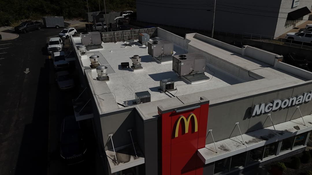 Close aerial of a restaurant membrane roof and its rooftop units