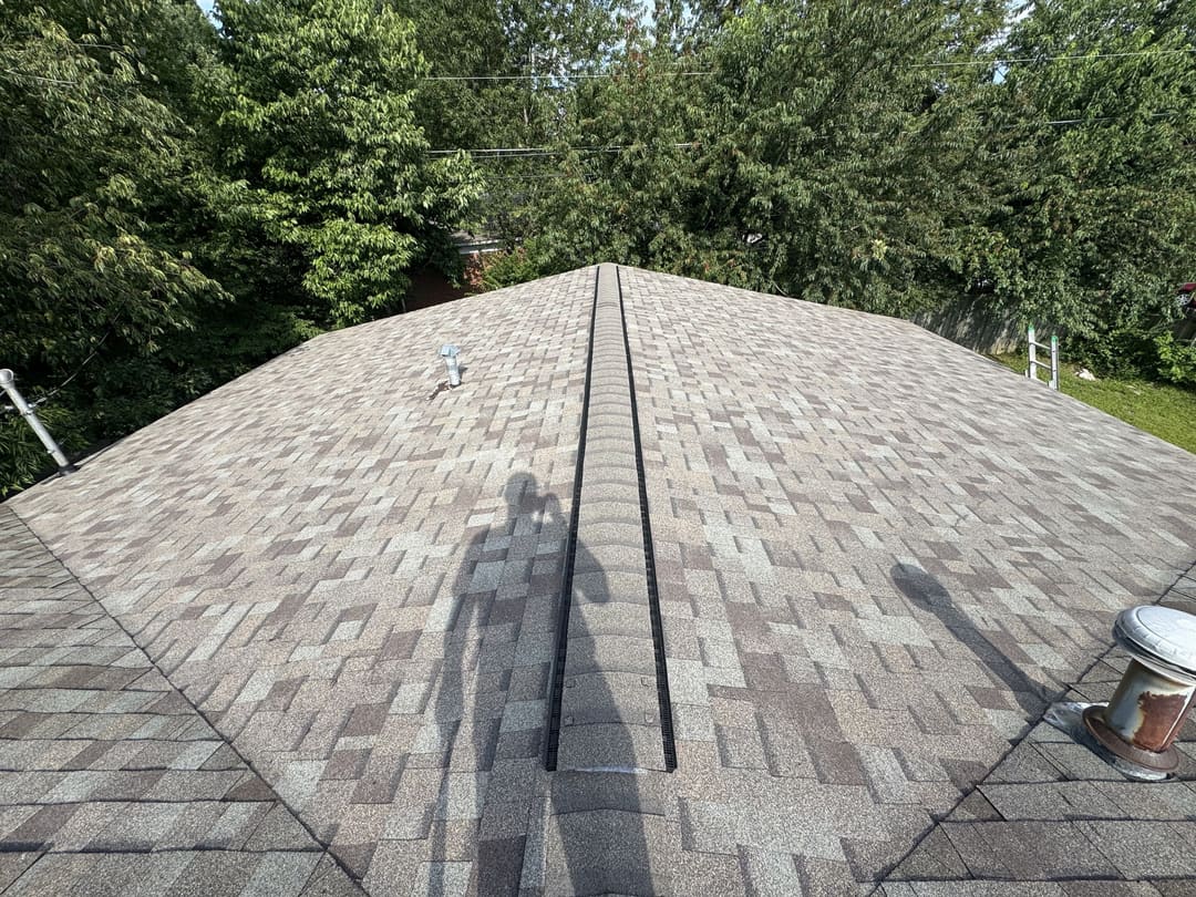 Shingle roof with a ridge vent running along the peak