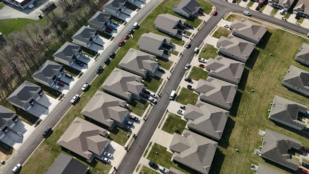 Rows of shingle roofs on a new subdivision