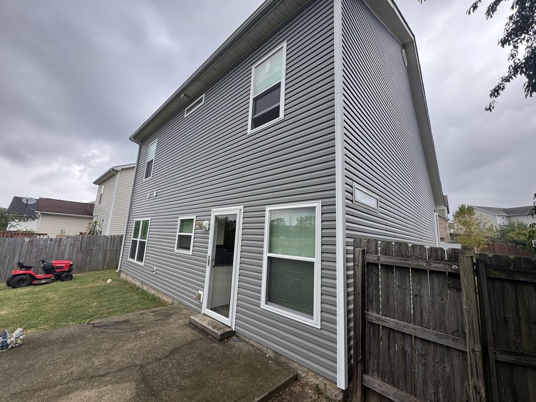 New vinyl windows and white siding trim in Norandex Smoke vinyl siding on the back of a two story home in Georgetown, KY